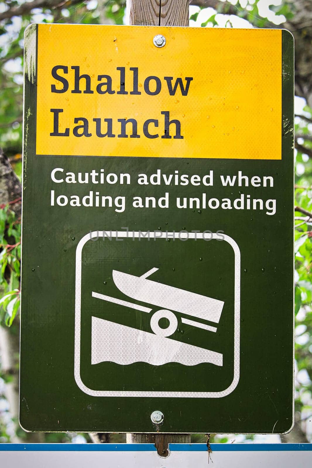 A shallow boat launch sign advising caution.