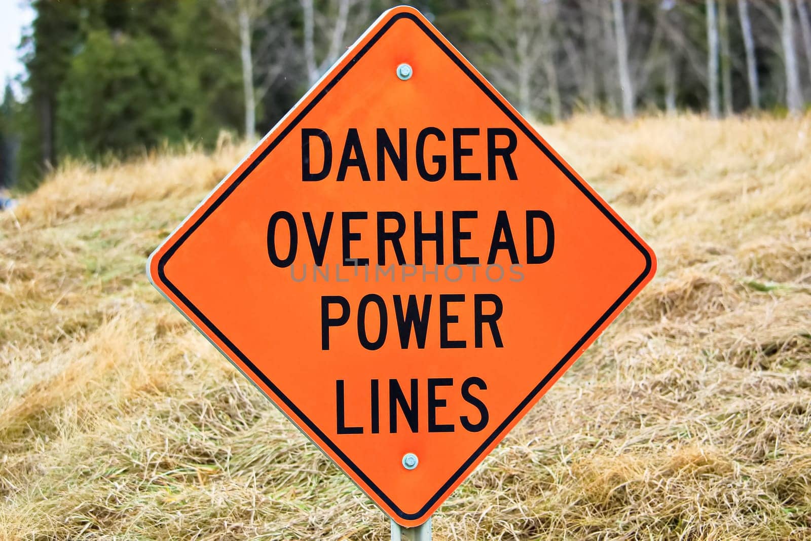 Closeup of a danger overhead power line sign.