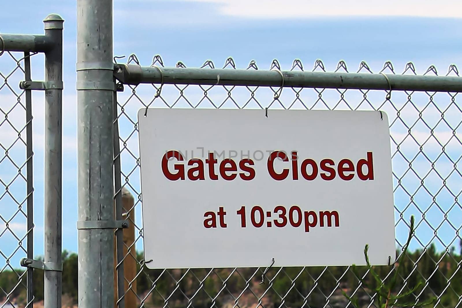 Gate closes at 10:30 pm sign at a beach.