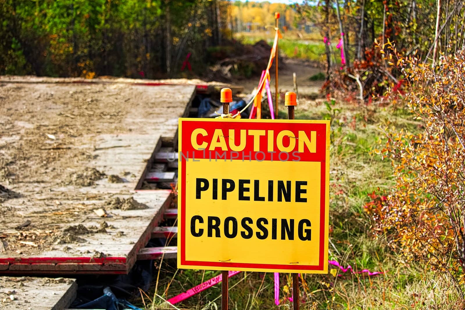 Closeup of a caution pipeline crossing sign.