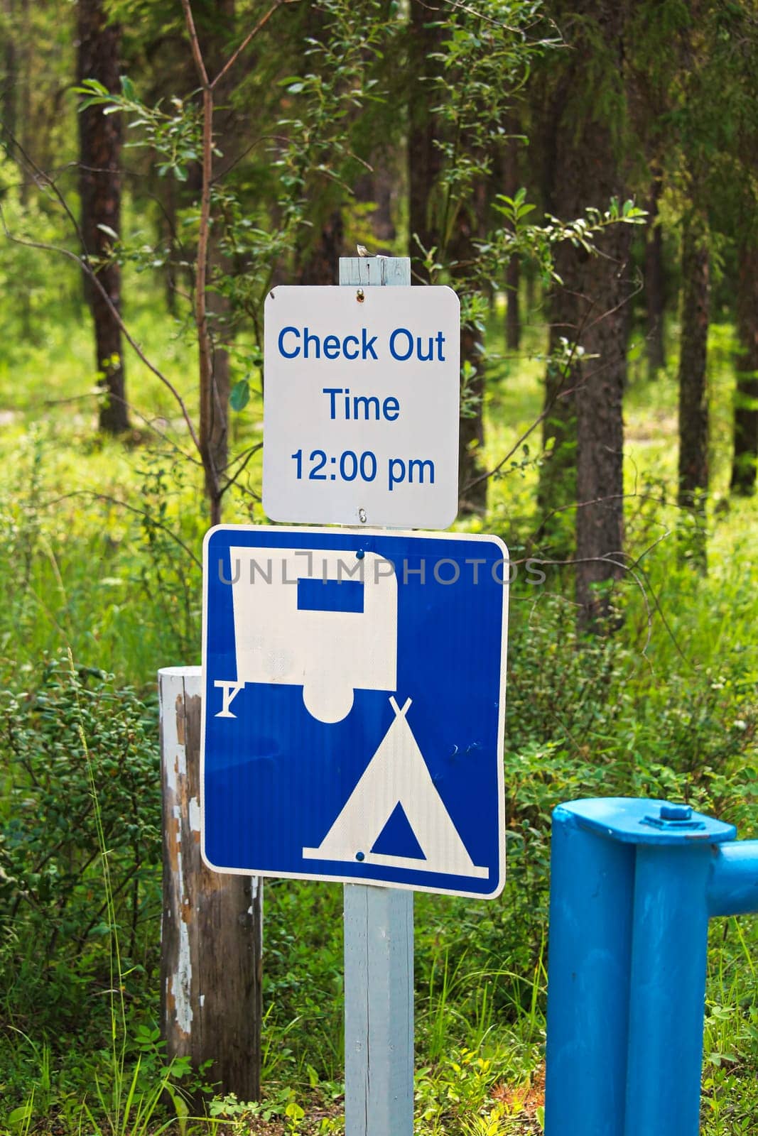 A camping check out time 12:00 pm message sign.