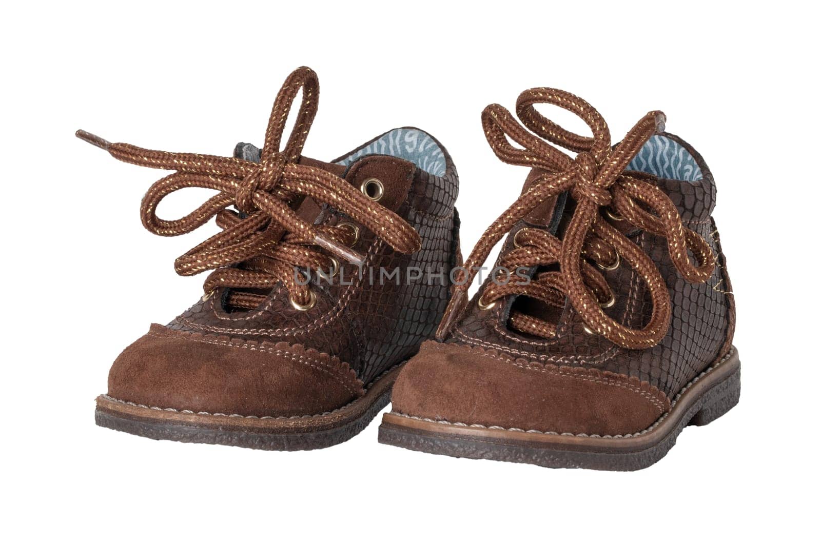 Child shoe fashion. A pair of elegant brown leather shoes with shoelaces for little boys isolated over white background. Leather and suede shoes for spring or autumn.