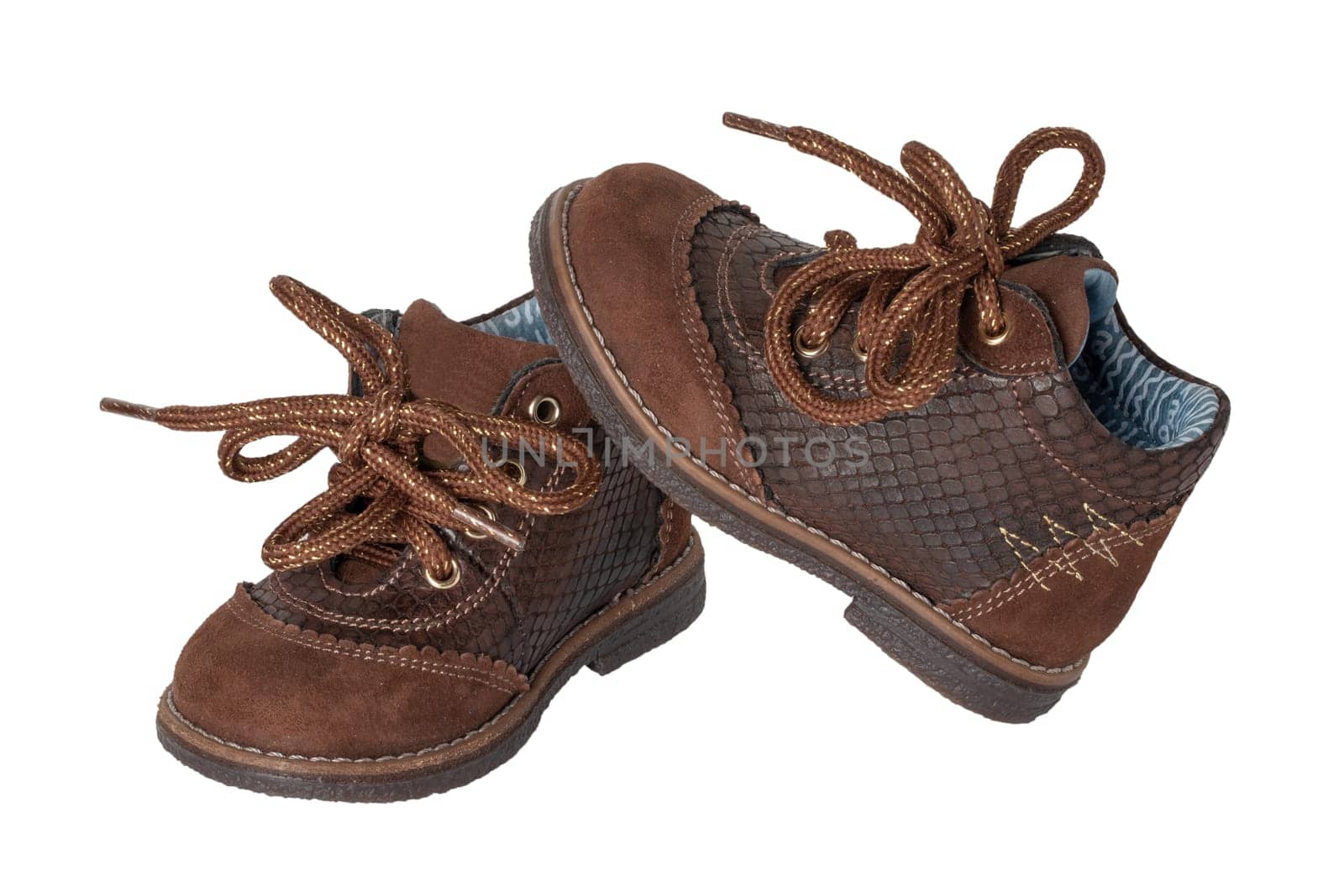 Child shoe fashion. A pair of elegant brown leather shoes with shoelaces for little boys isolated over white background. Leather and suede shoes for spring or autumn.