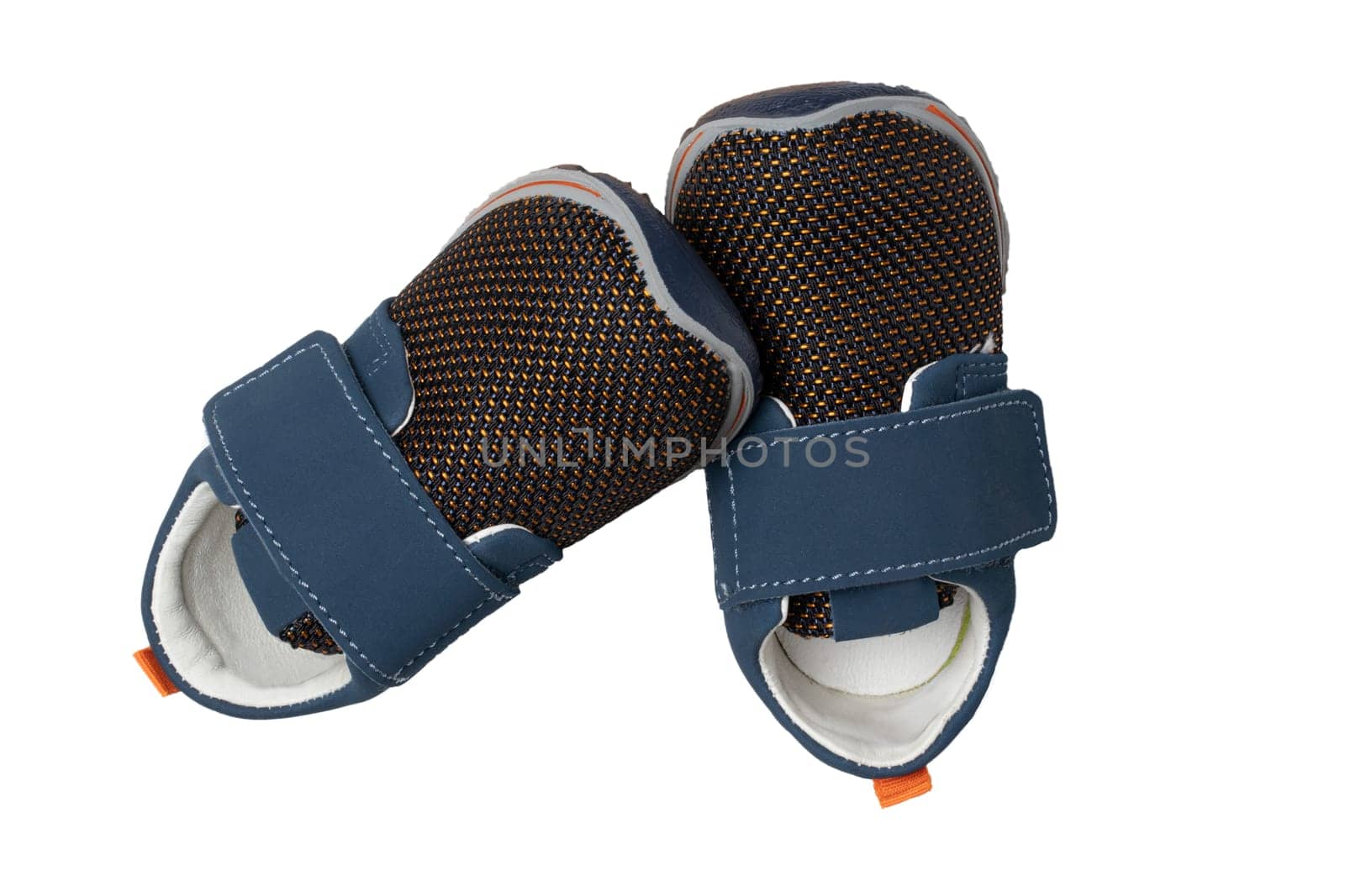Child shoe fashion. A pair of blue denim child sneaker or sport shoes isolated on a white background. Elegant and trendy shoes.