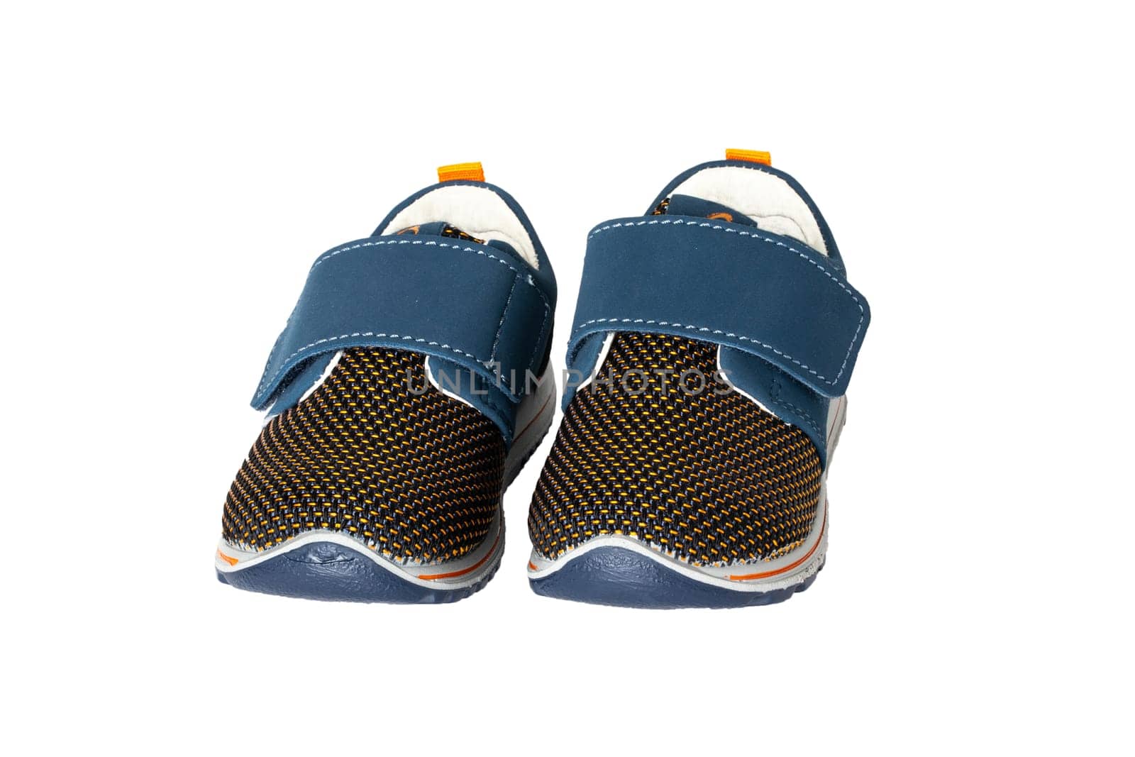 Child shoe fashion. A pair of blue denim child sneaker or sport shoes isolated on a white background. Elegant and trendy shoes.