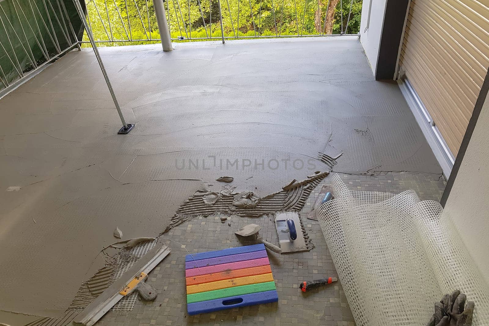 Balcony floor tiles installation. Laying tiles from porcelain. Interior remodeling theme.