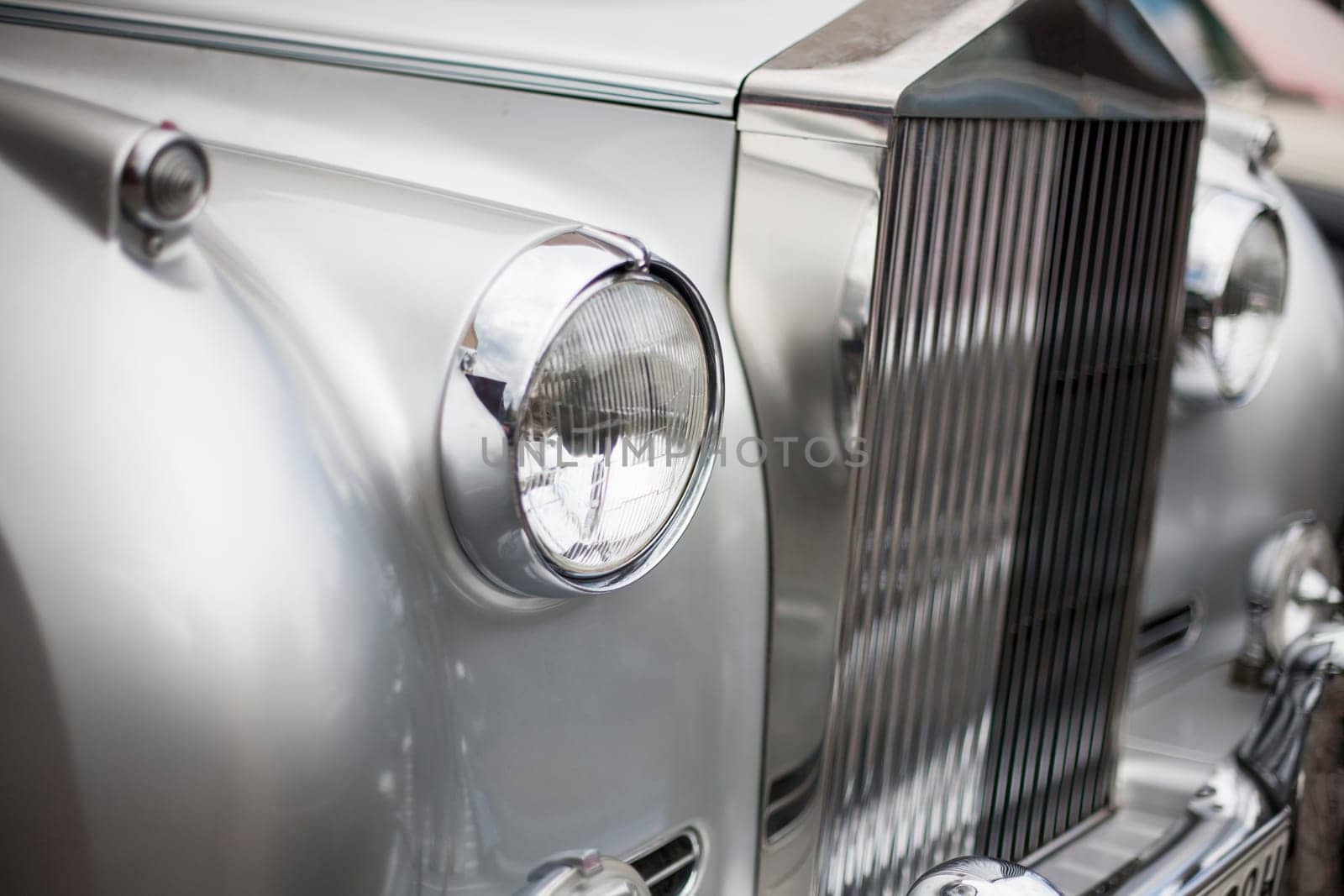 Classic vintage car. Close-up of headlights of luxurious vintage vehicle