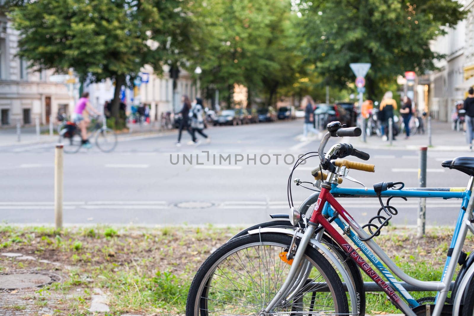 BERLIN, GERMANY - JUNE 27, 2018: Couple of bikes in city. Bicycle parked next to sidewalk on the street