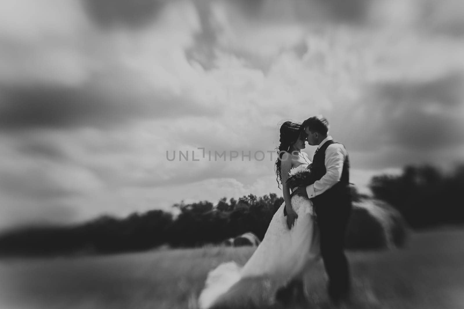 bride and groom near hay barn