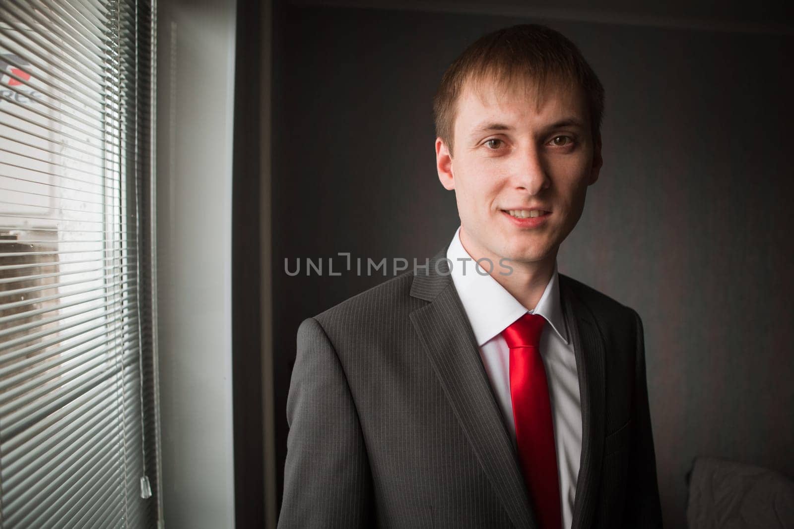 Hands of wedding groom getting ready in suit