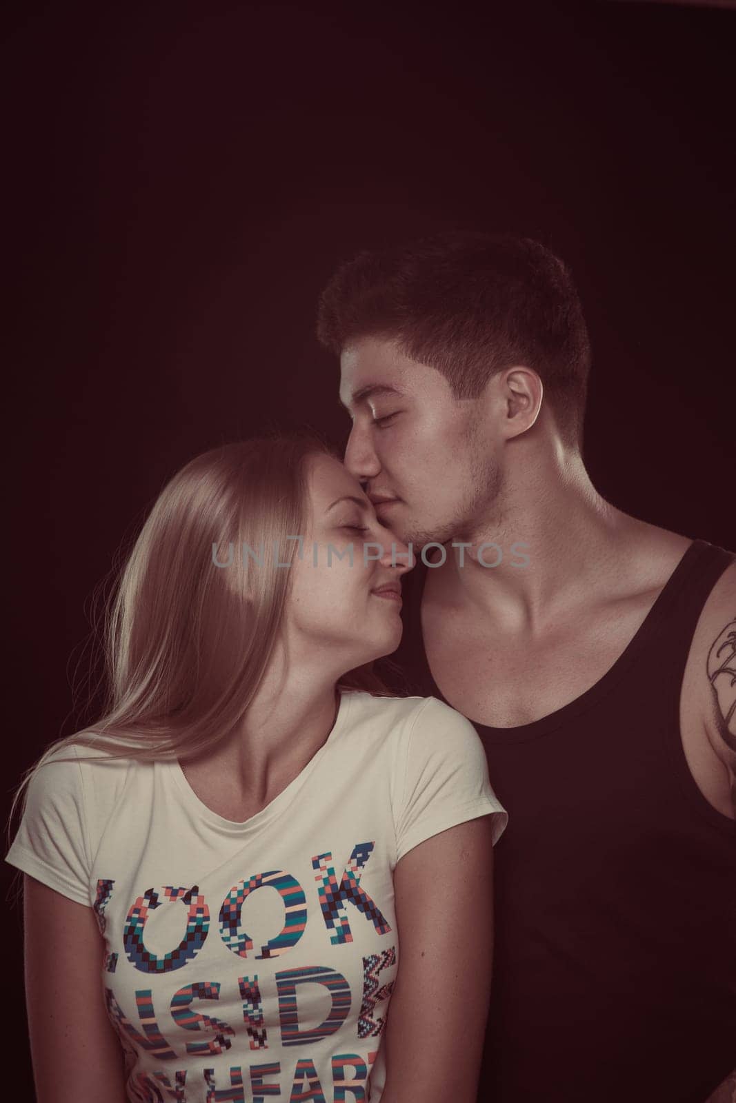 Shot of a passionate loving couple. Over black background.