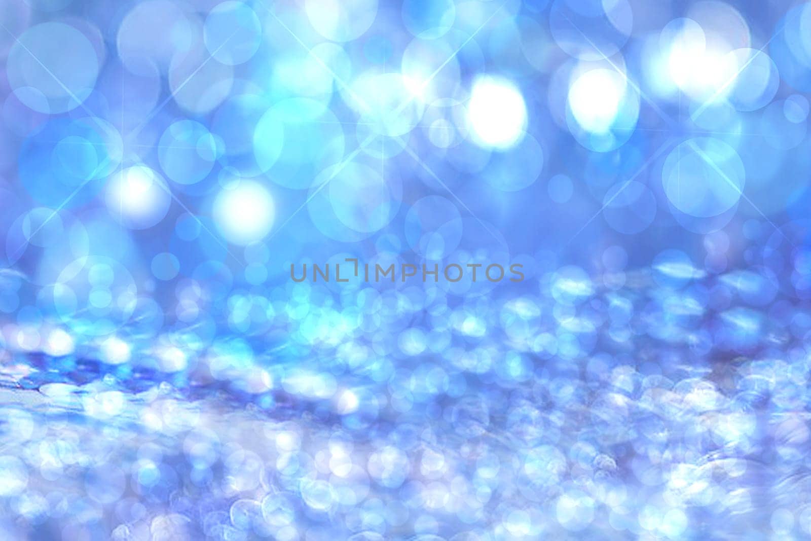 Abstract blurred festive blue background  for winter Christmas with bokeh defocused blue lights.