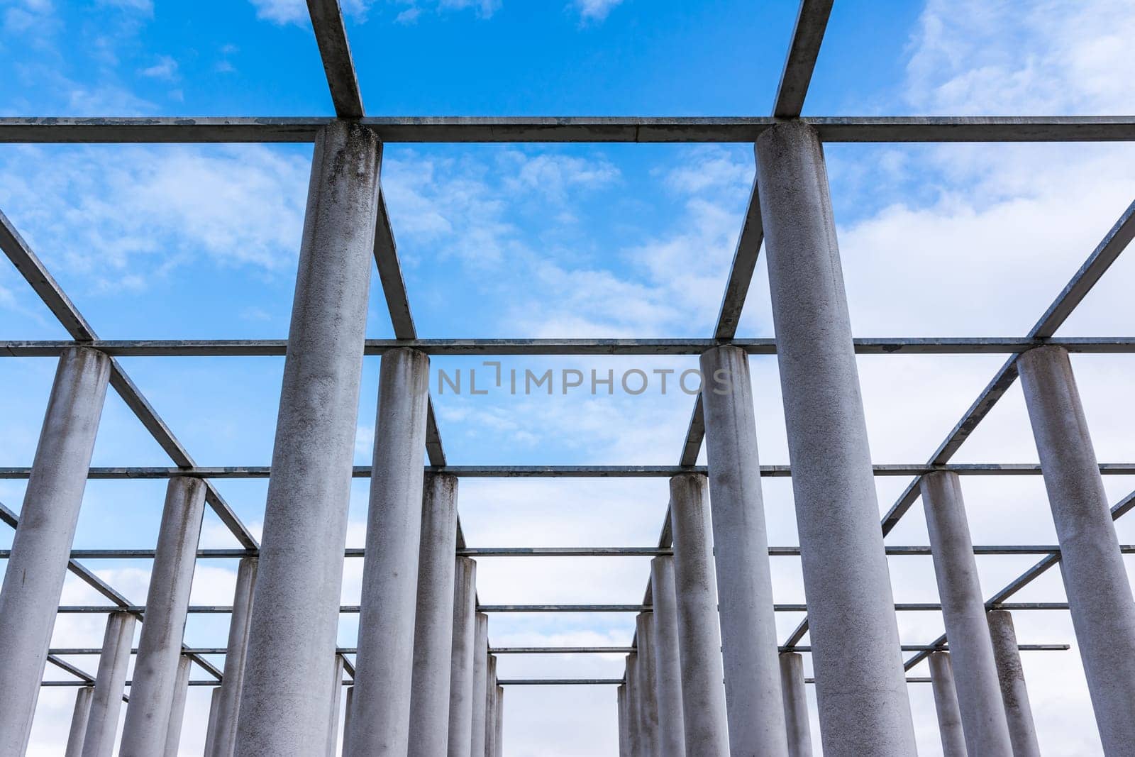 Cement Columns Chair Rough Texture Perspective Overhead Grid Geometric Pattern Design Outdoor Park Public Upright Minimal Bright Stone