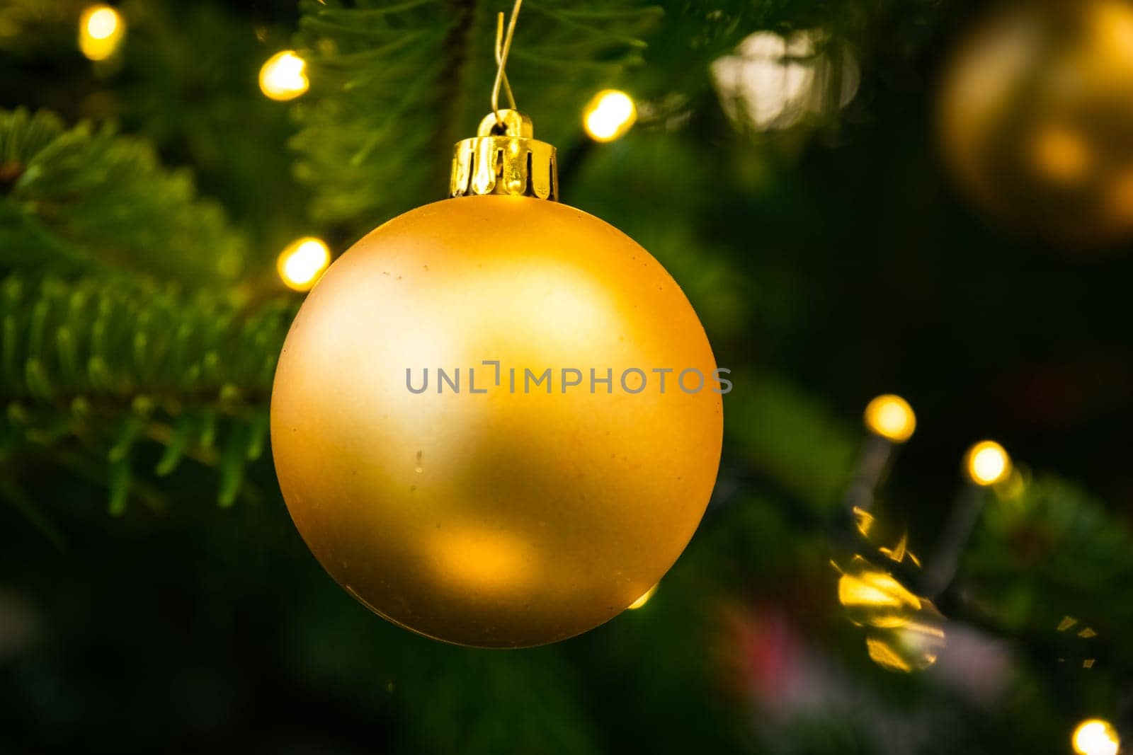 Christmas Tree Ball Ornament Festive Holiday Decoration Gold Closeup Depth of Field Bokeh Centered