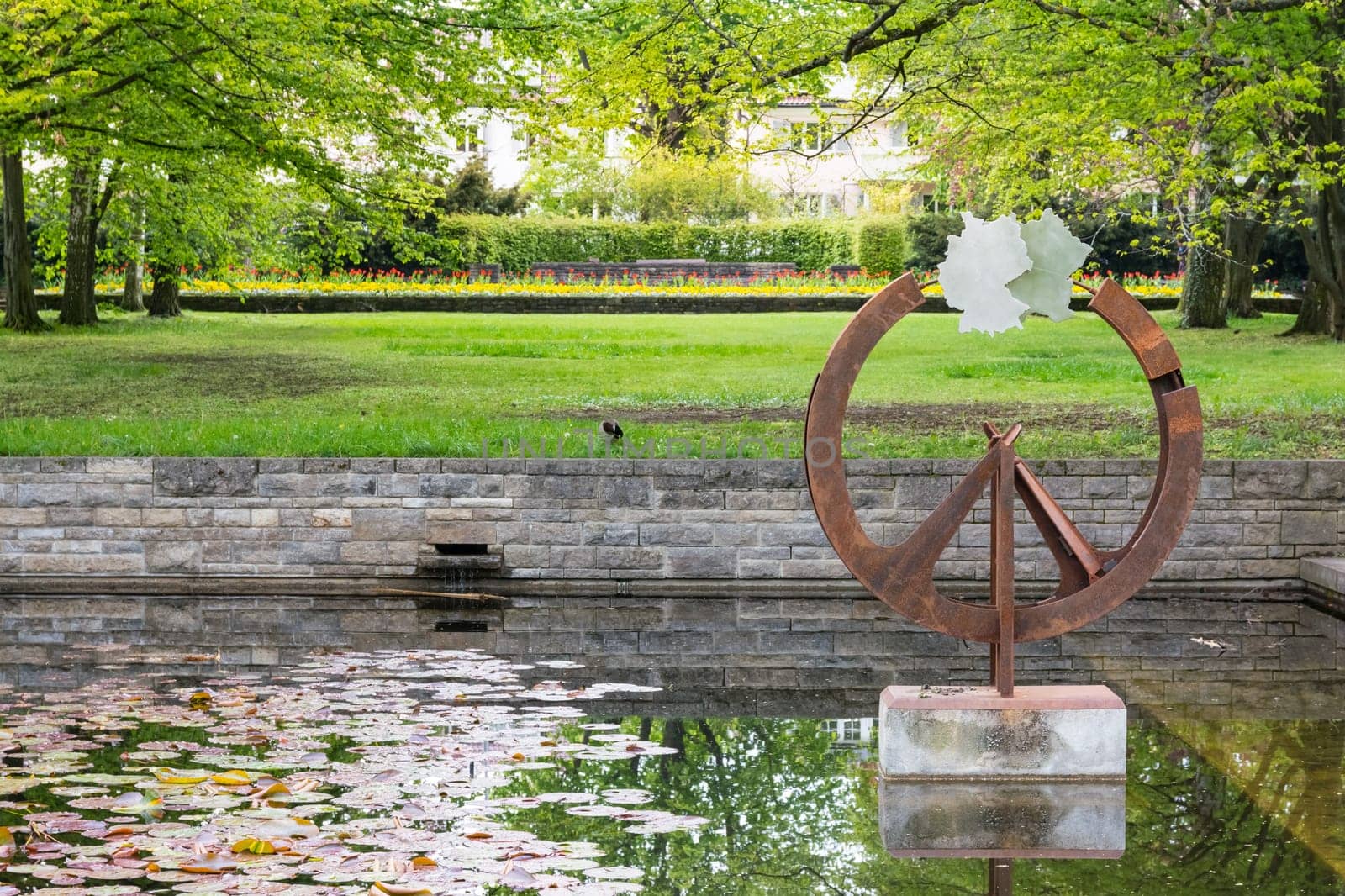 Germany Country Shape Statue Art Decoration in Spring Park Green Grass Water Reflection
