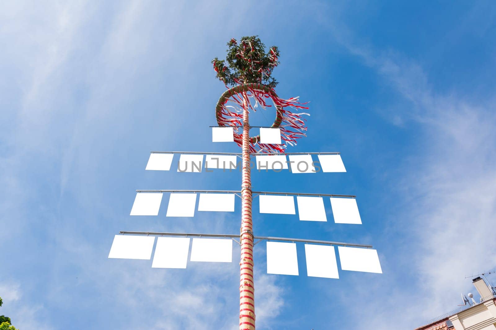 Blank White Signs on Traditional German May Pole Maibaum Blue Skies Local Tradition