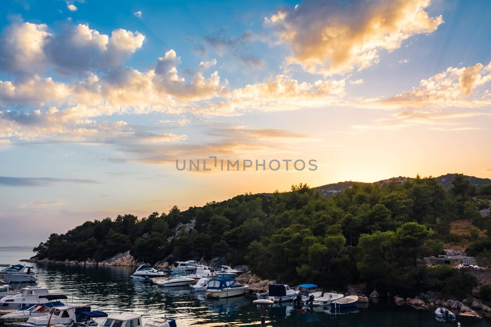Beautiful Sunset Clouds over Mountains and Ocean in Croatia with Fiery Colors on Landscape