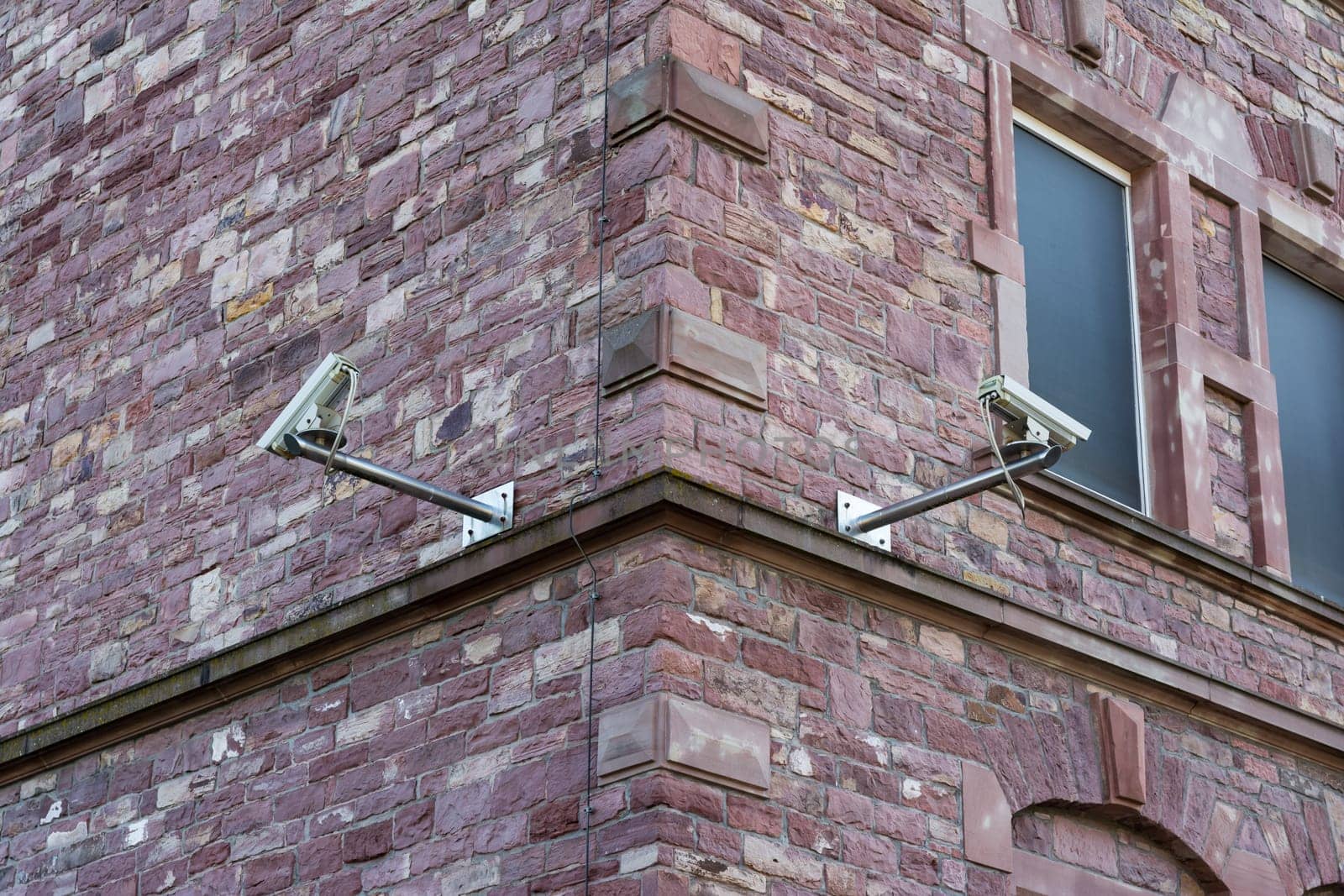 Two Security Cameras on Brick Wall Corner Security Change Architecture