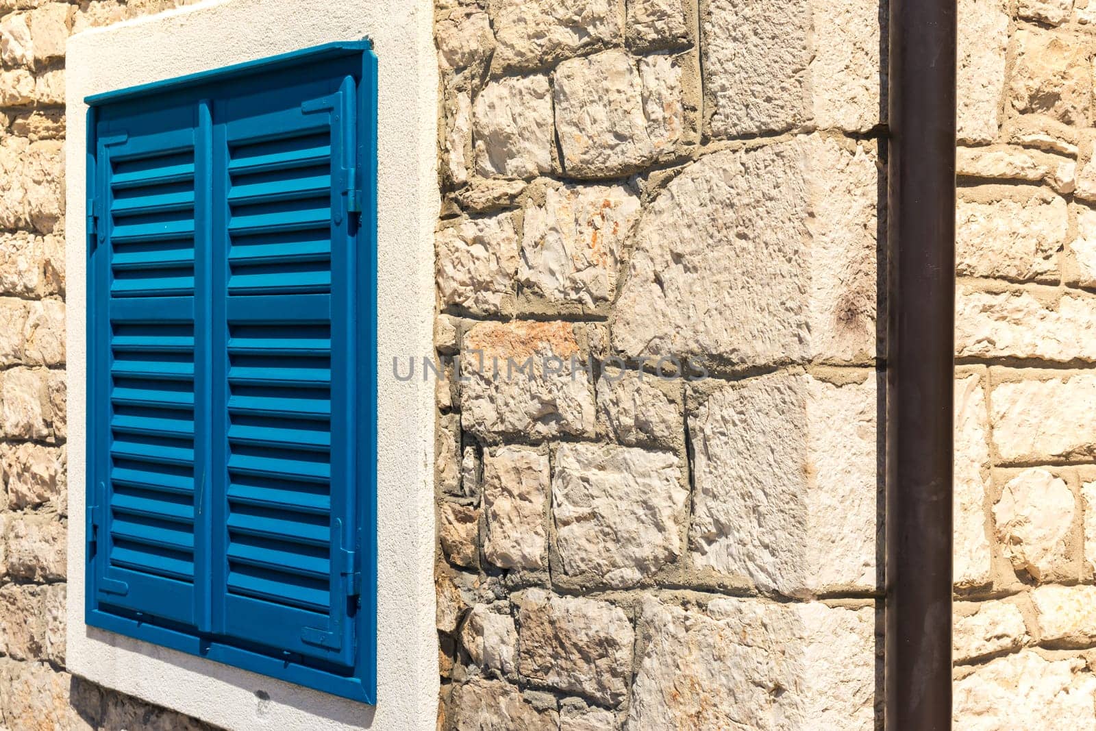 Bright Blue Vintage Window Shutters on Corners of Stone Building Village Old