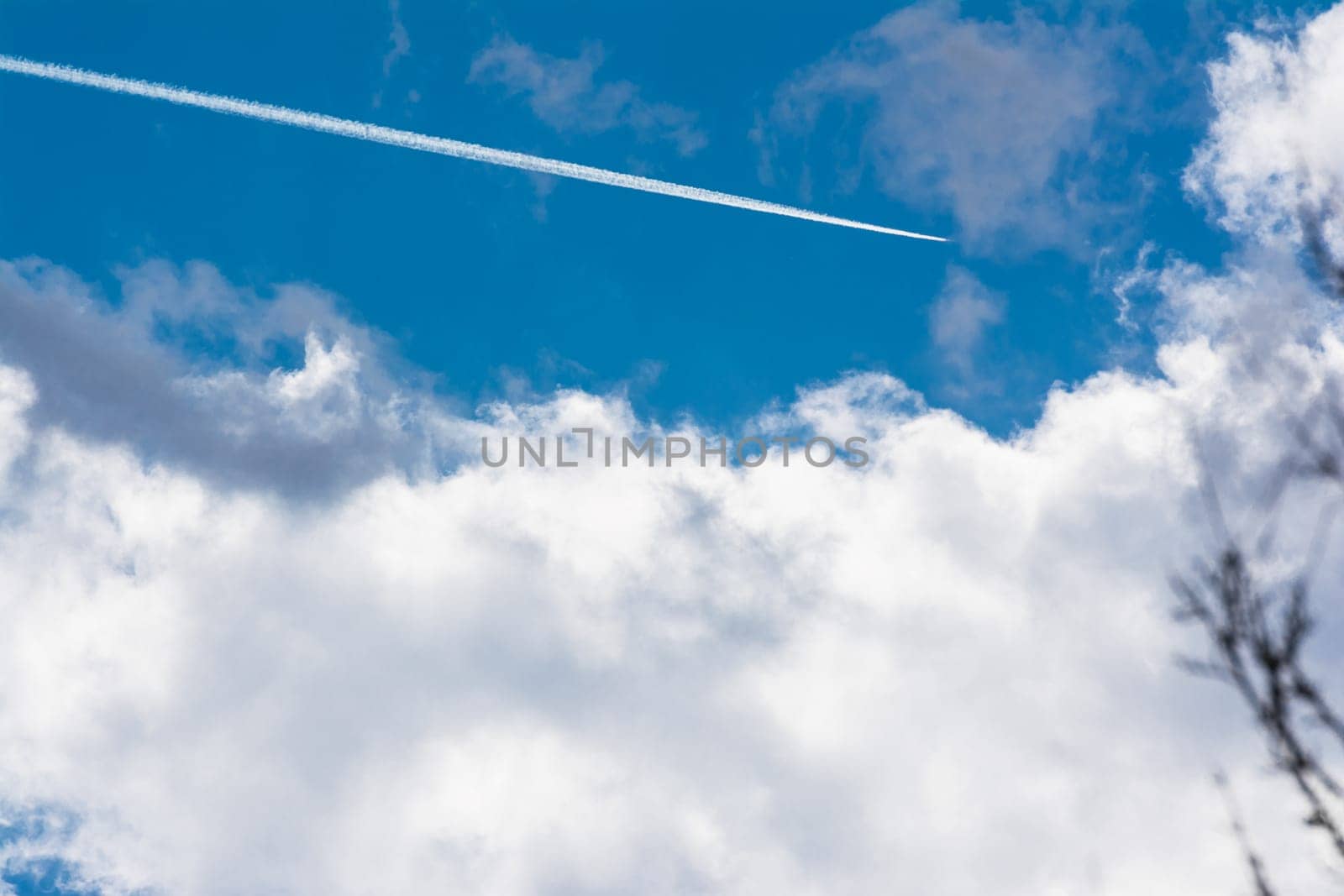 White Clouds Blue Sky Fluffy Sun Flare Airplane Trail  Sunny Daytime Texture Background