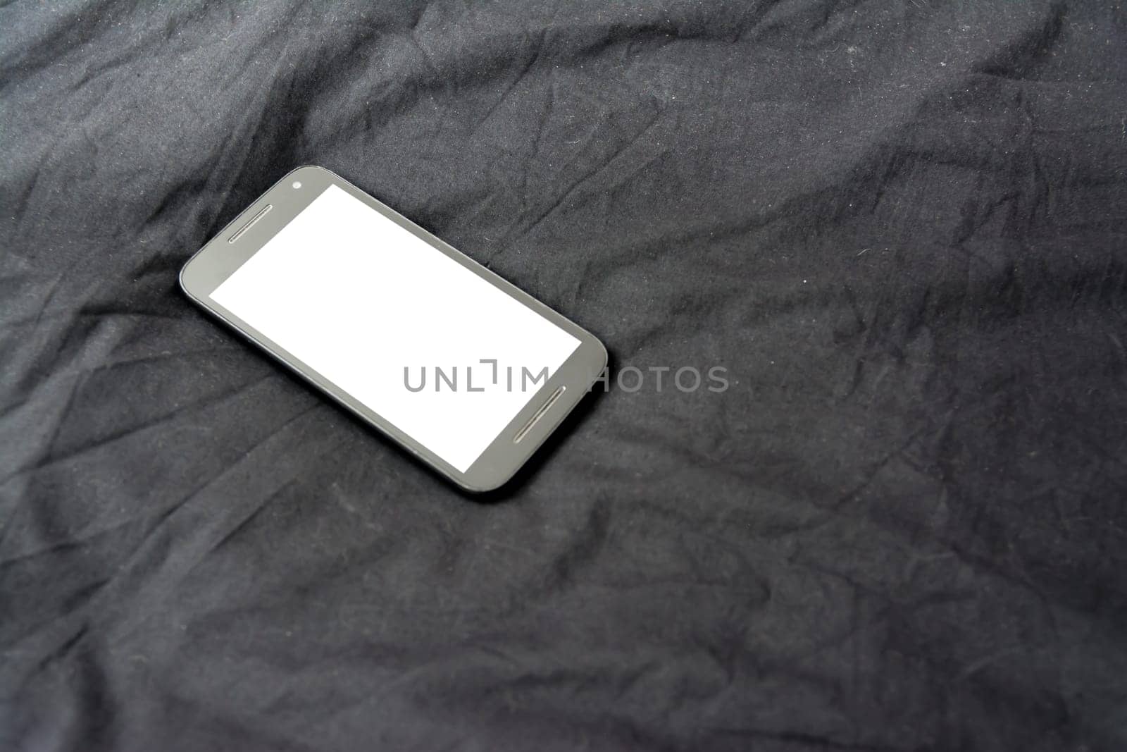 Cell Phone on Black Blanket White Screen Isolated Simple Background Fabric