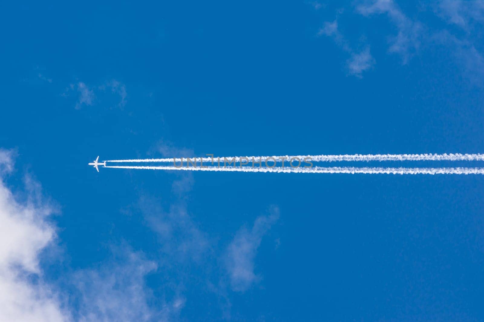 White Clouds Blue Sky Fluffy Sun Flare Airplane Trail  Sunny Daytime Texture Background