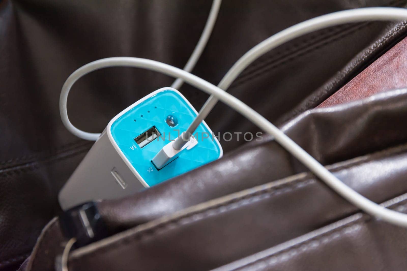 USB Battery Bank on Leather Bag Commute Technology Charging Business Wire Cable