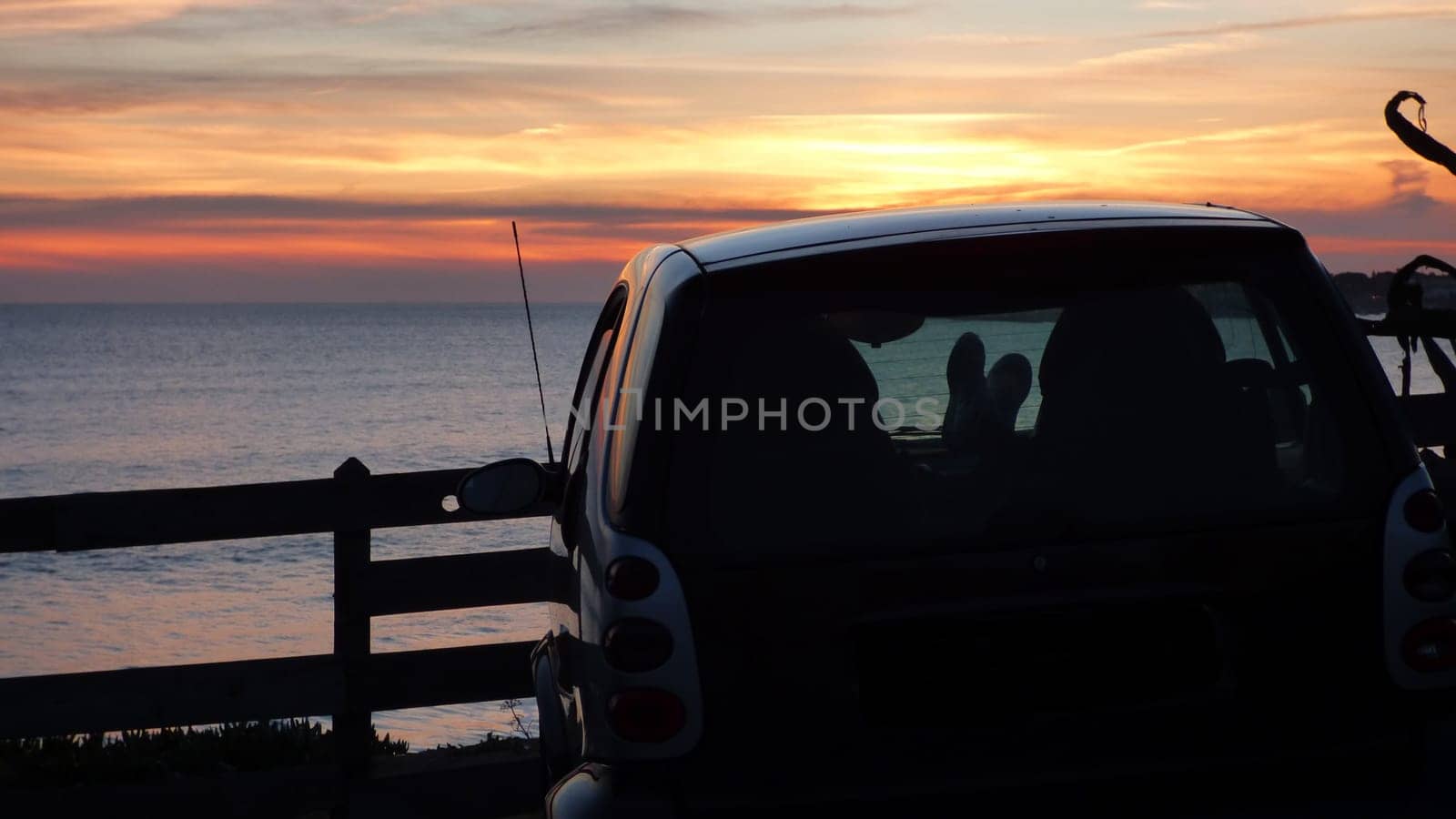 Sitting in Electric Car Cliffside Sunset Beach Ocean Landscape