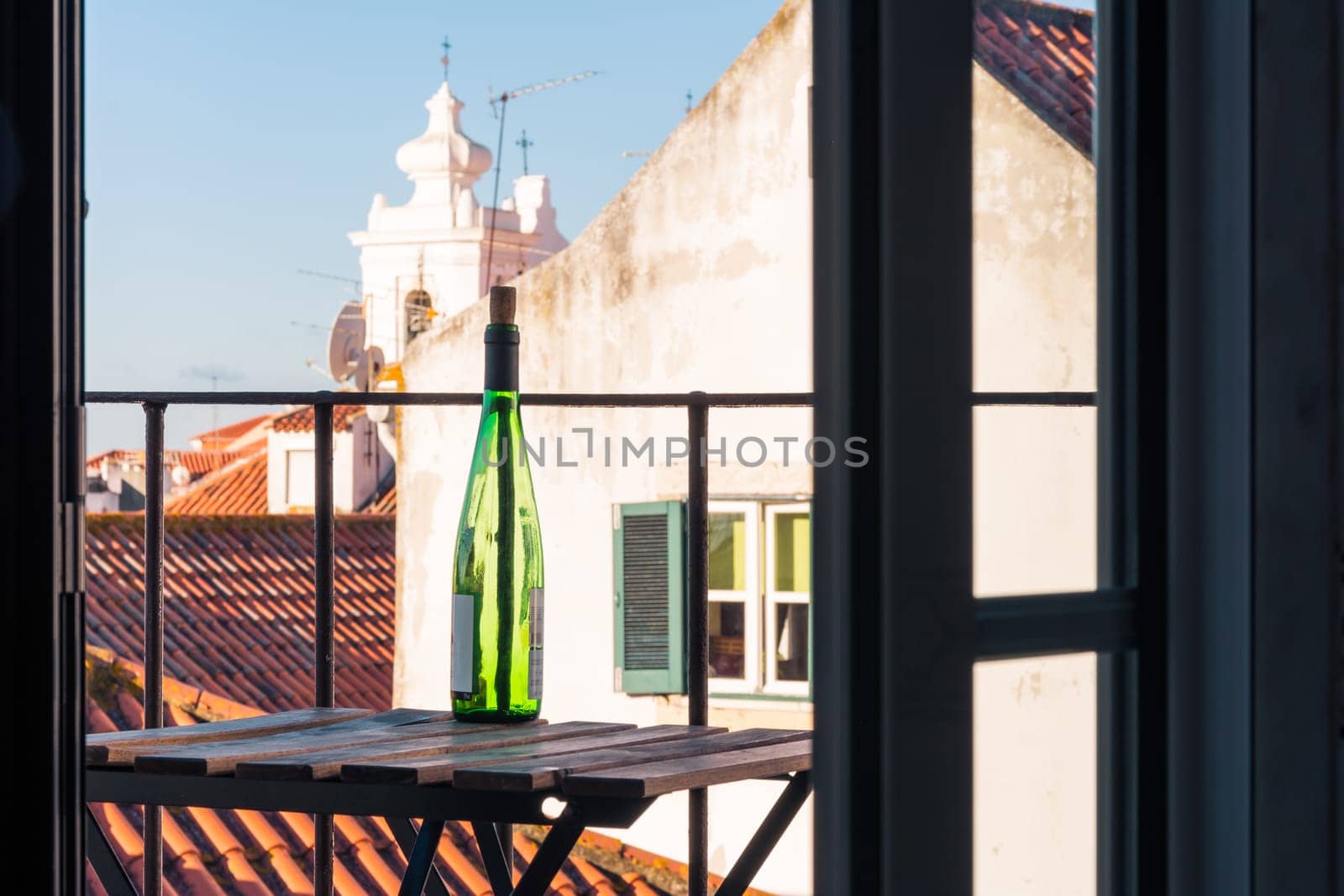Empty Wine Bottle on Wooden Balcony Table over Alfama European Vacation Beautiful Day Relaxing