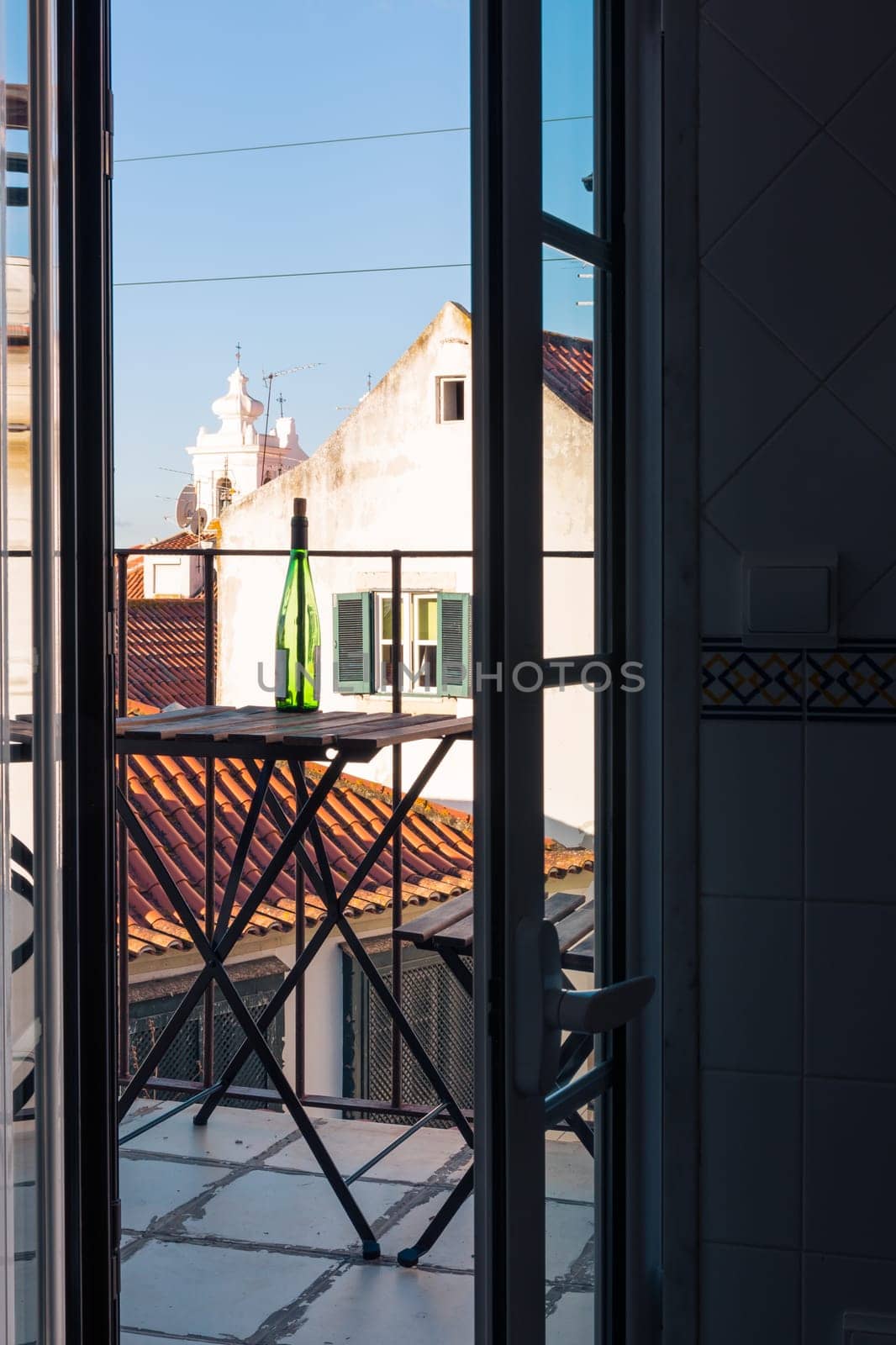 Empty Wine Bottle on Wooden Balcony Table over Alfama European Vacation Beautiful Day Relaxing