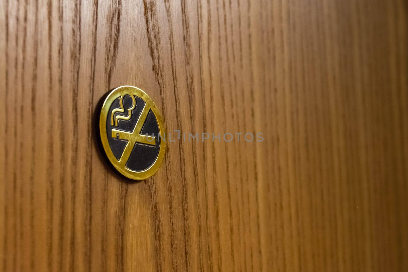 Golden Metal No Smoking Sign on Brown Wooden Door Hotel