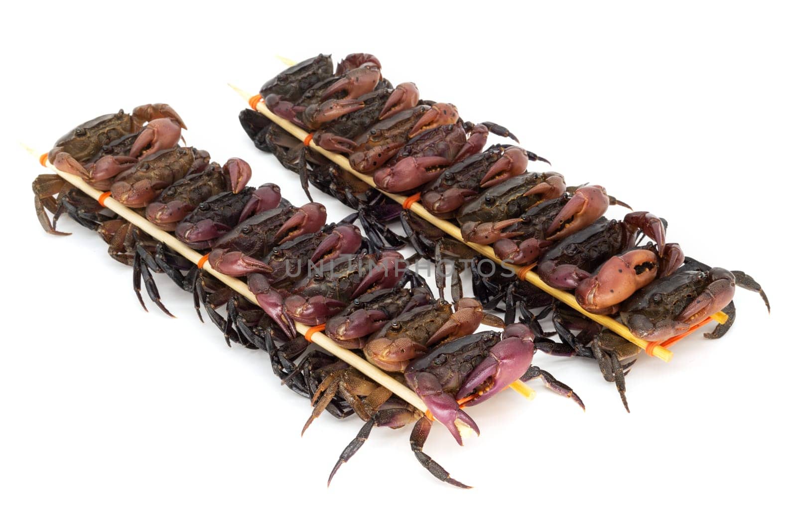 close up of skewered crabs, traditional food in asia