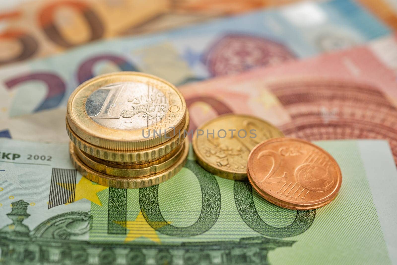 coins stack with euro bills