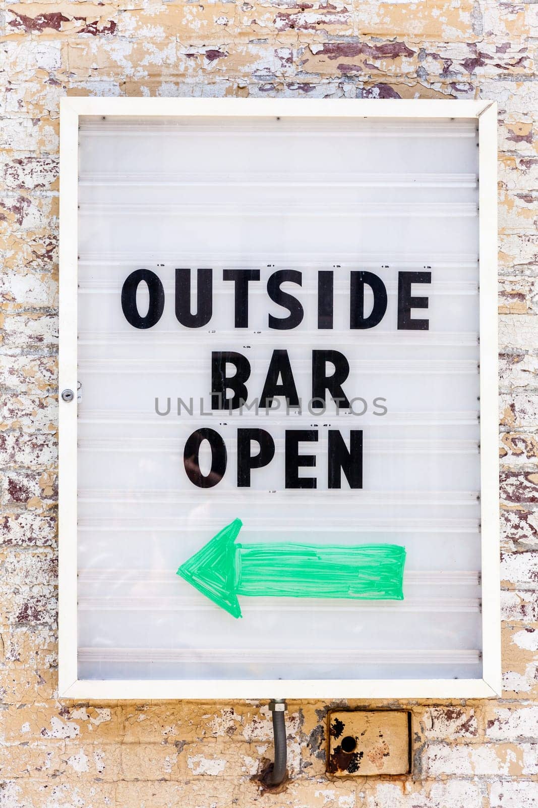 Sign on the wall reading: Outside Bar Open