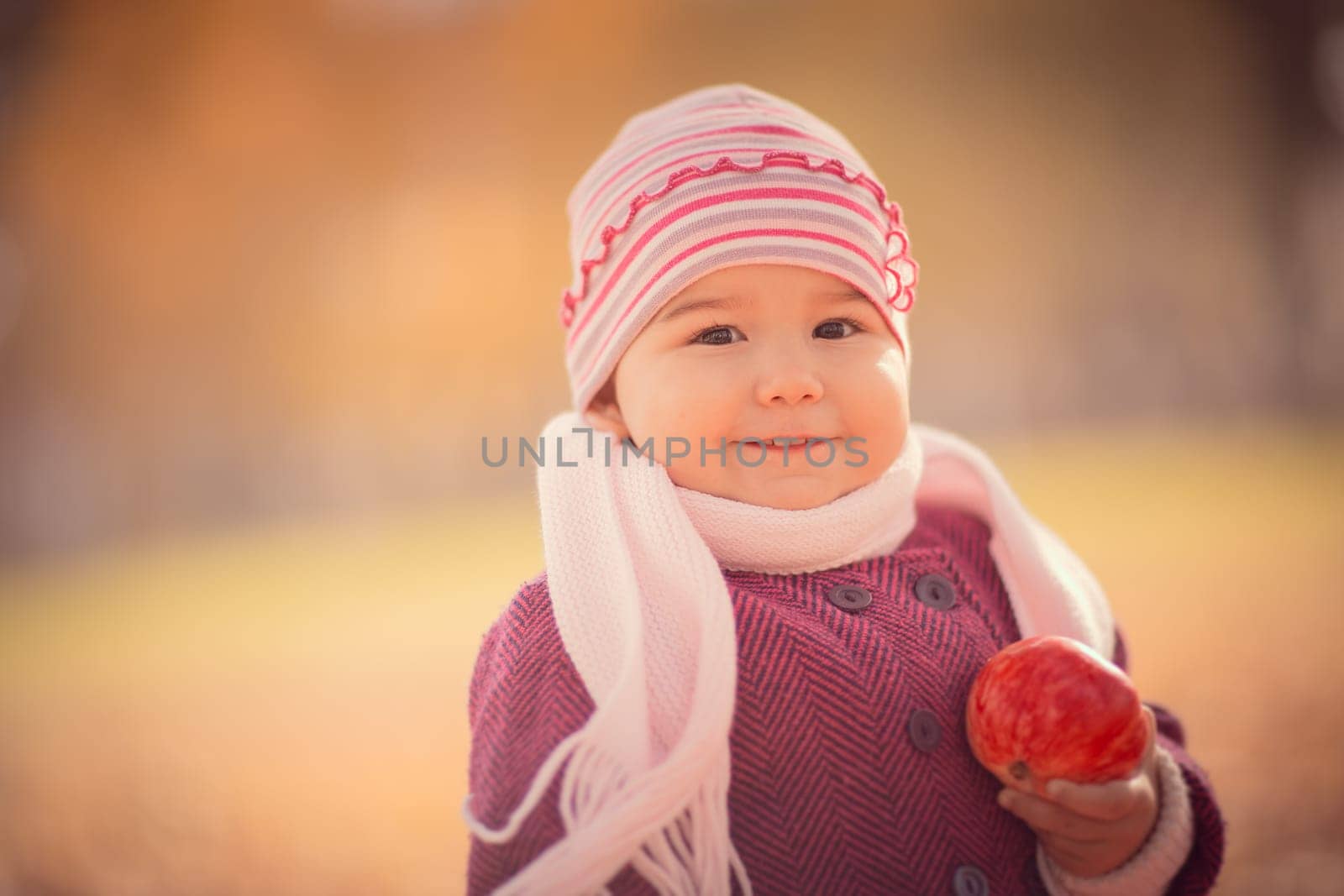 Beautiful outdoor autumn portrait of adorable toddler girl