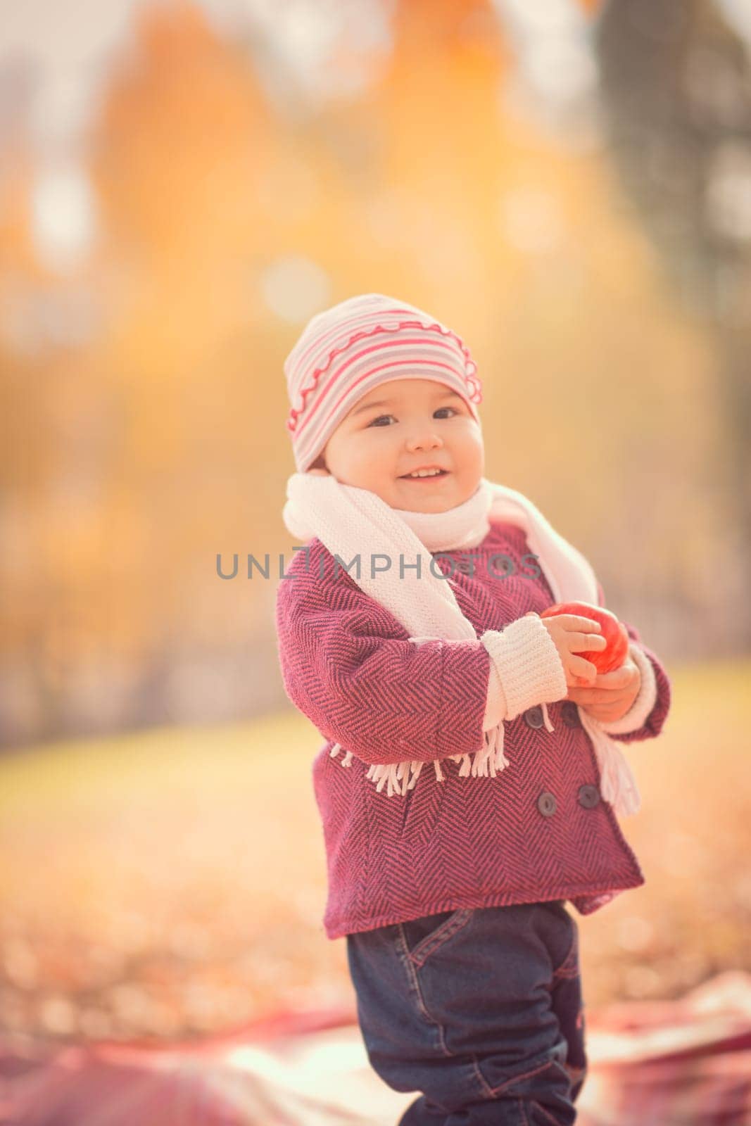 Beautiful outdoor autumn portrait of adorable toddler girl