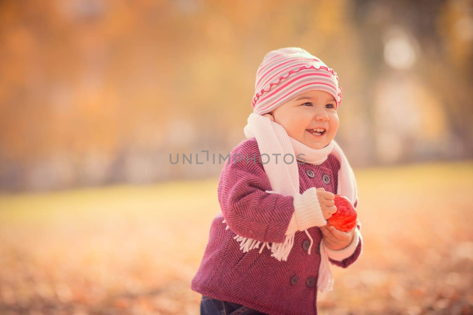 Beautiful outdoor autumn portrait of adorable toddler girl