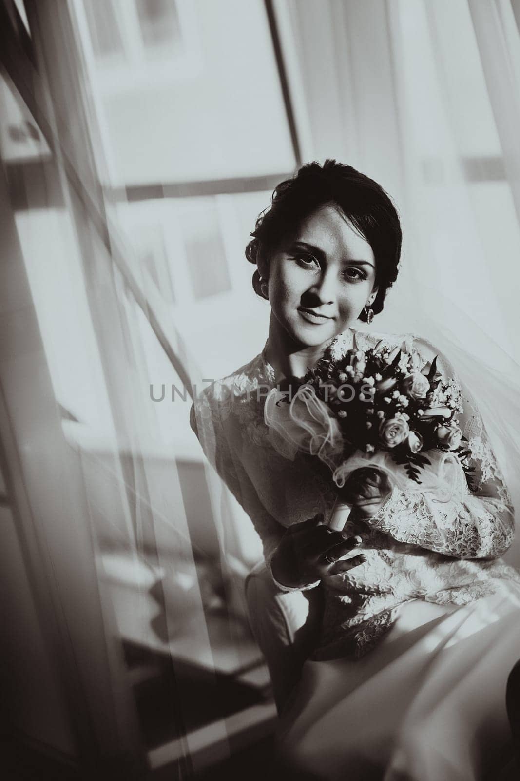 silhouette of the bride weared in dress and veil with a bouquet
