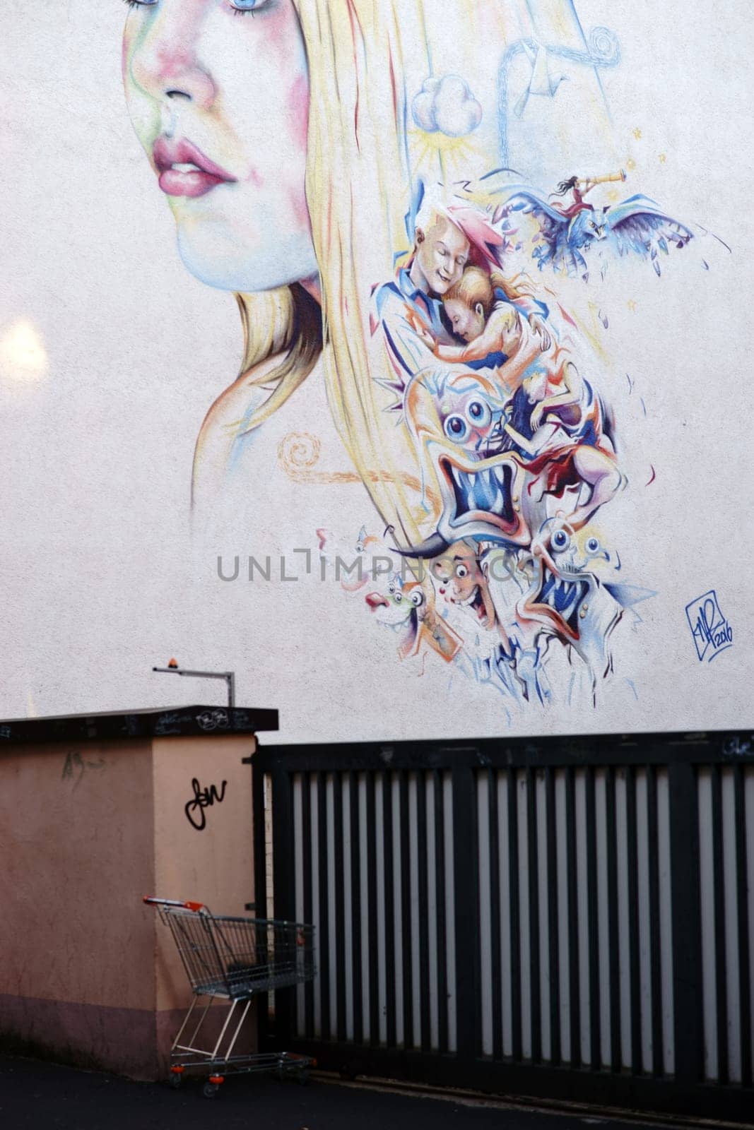 Aschaffenburg, Germany - November 17, 2018: The portrait of a young woman as an artful graffiti drawing on a building wall in a side street on November 17, 2018 in Aschaffenburg...