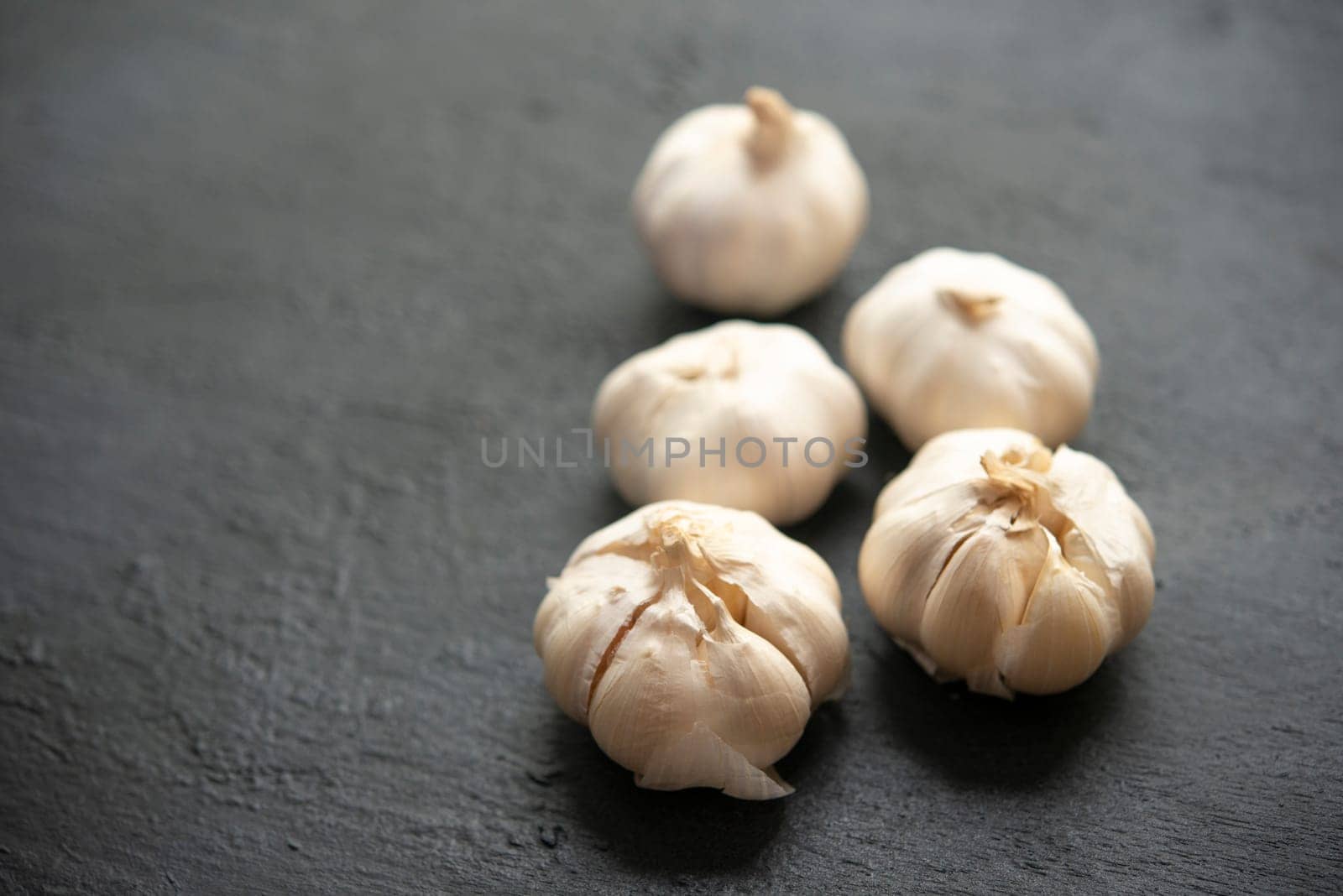Garlic with copy space on dark background.