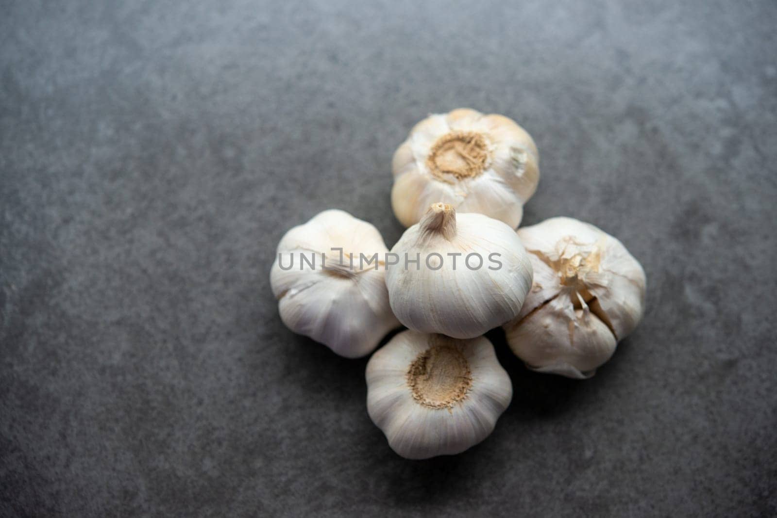 Top view garlic with copy space on dark background.