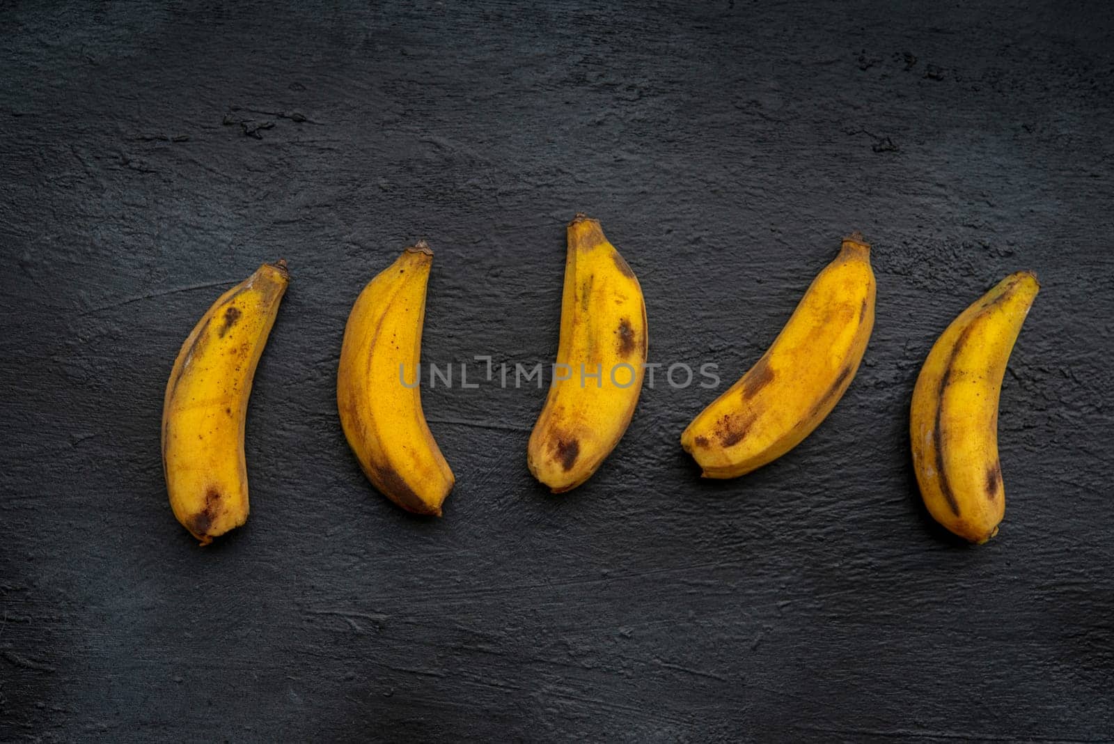 Overripe  bananas on dark background.