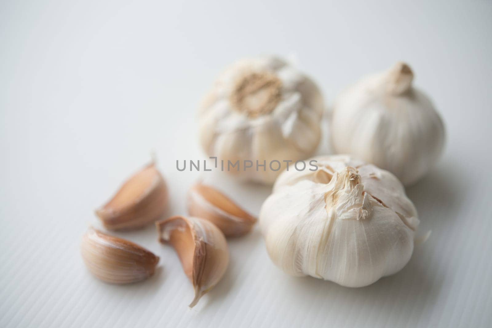 Garlic cloves and bulb on grey background.