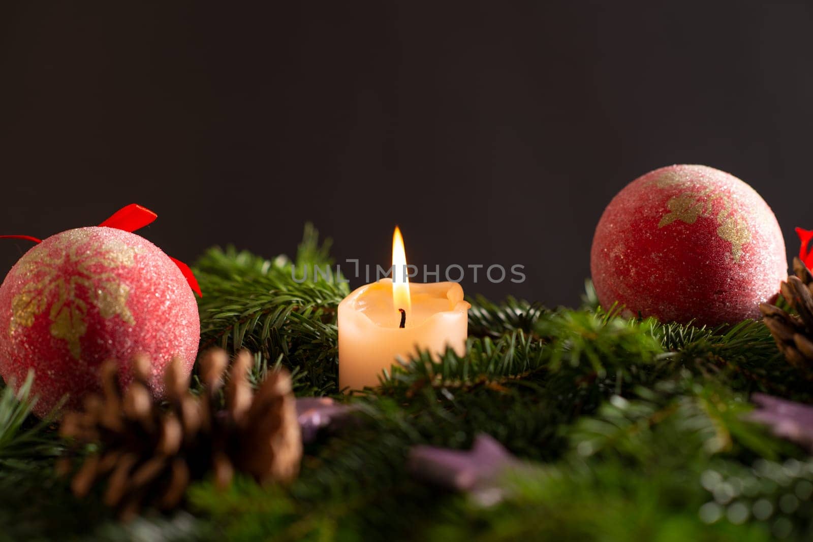 christmas decor with tree-balls, candle, branch and cone