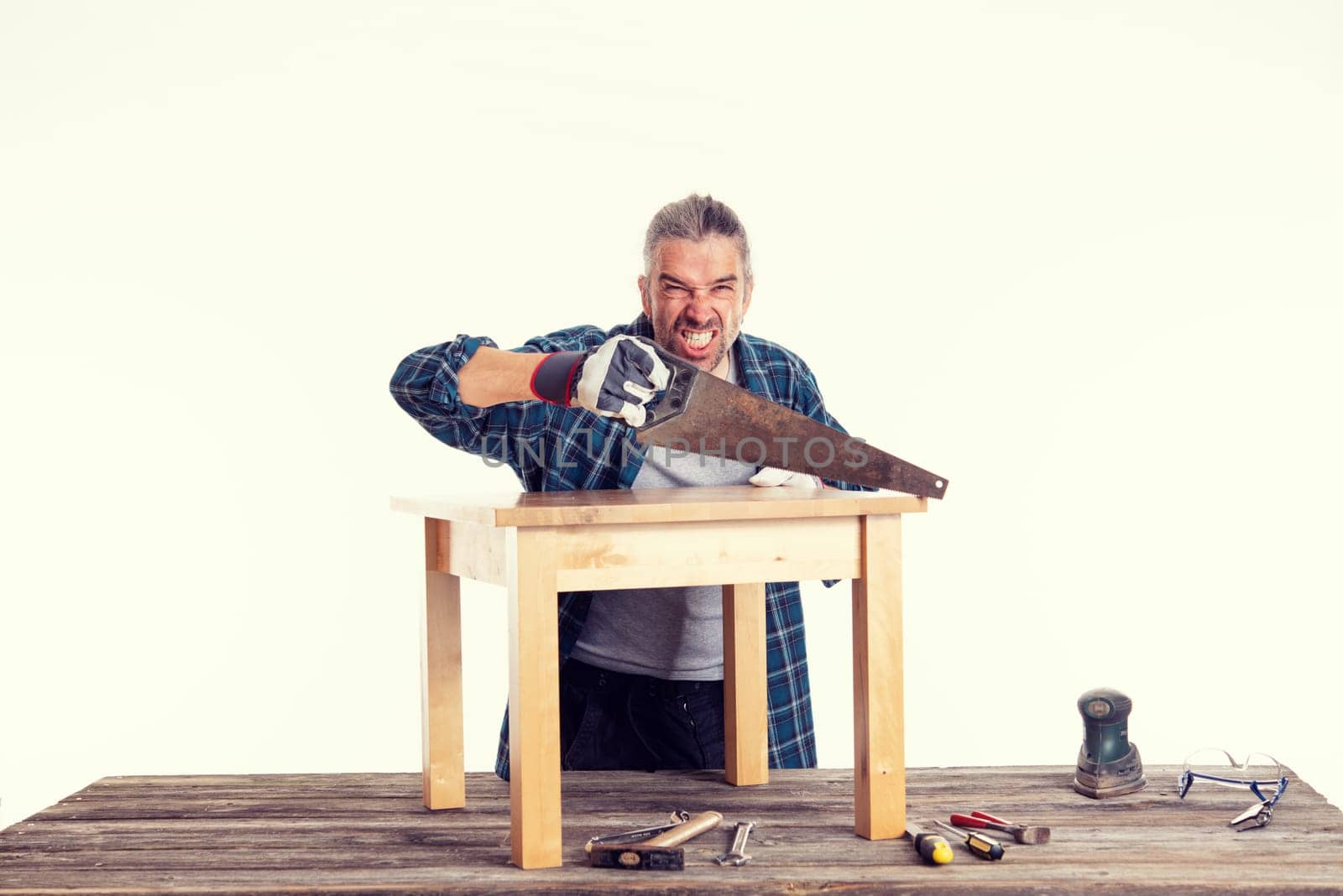 funny worker in blue plaid  shirt working with wood