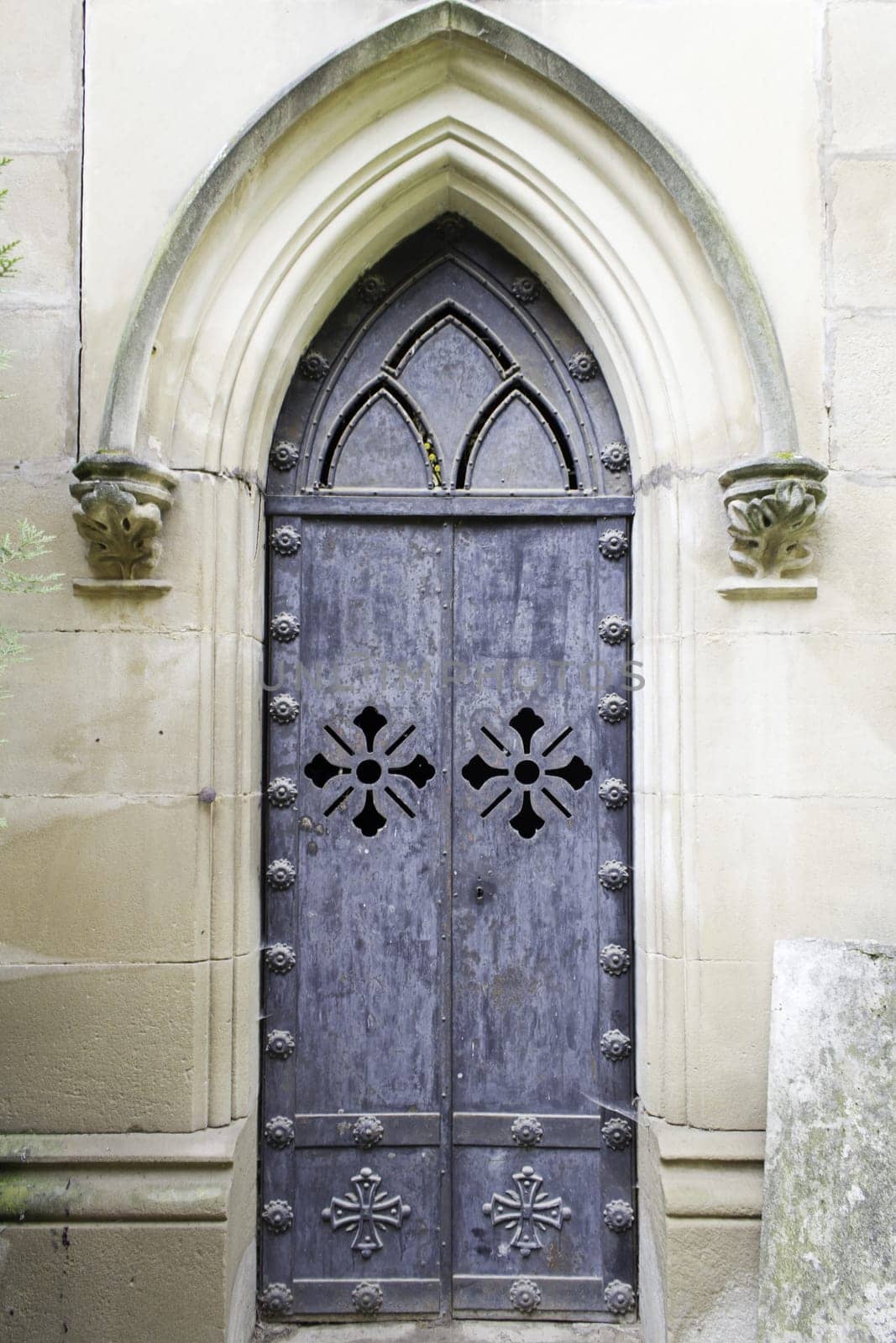 Old metal door with symbolic crosses, religion and construction