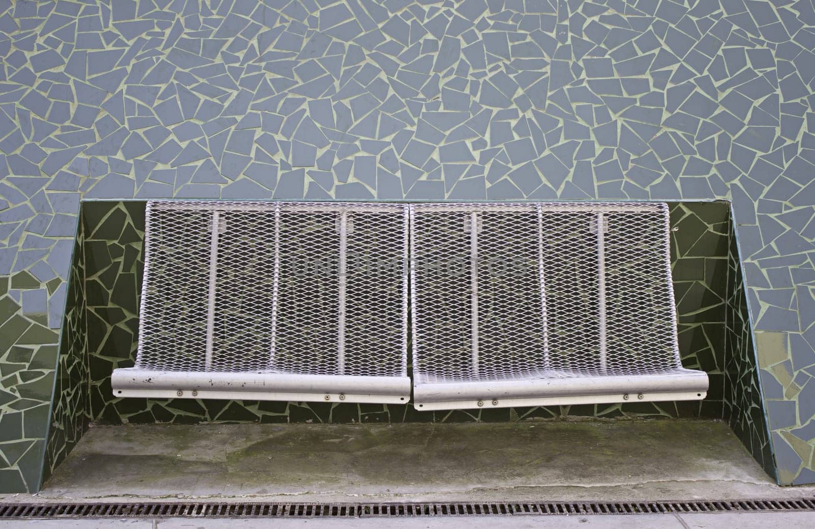 Iron metal bench inside tile structure, construction
