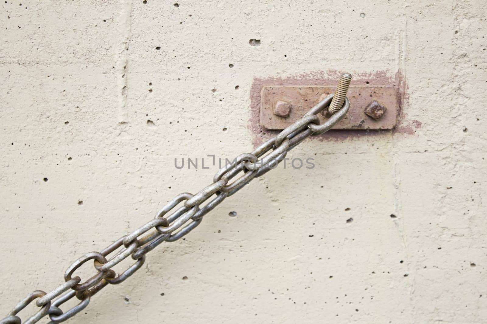 Iron chain bracket bolted on wall structure, construction