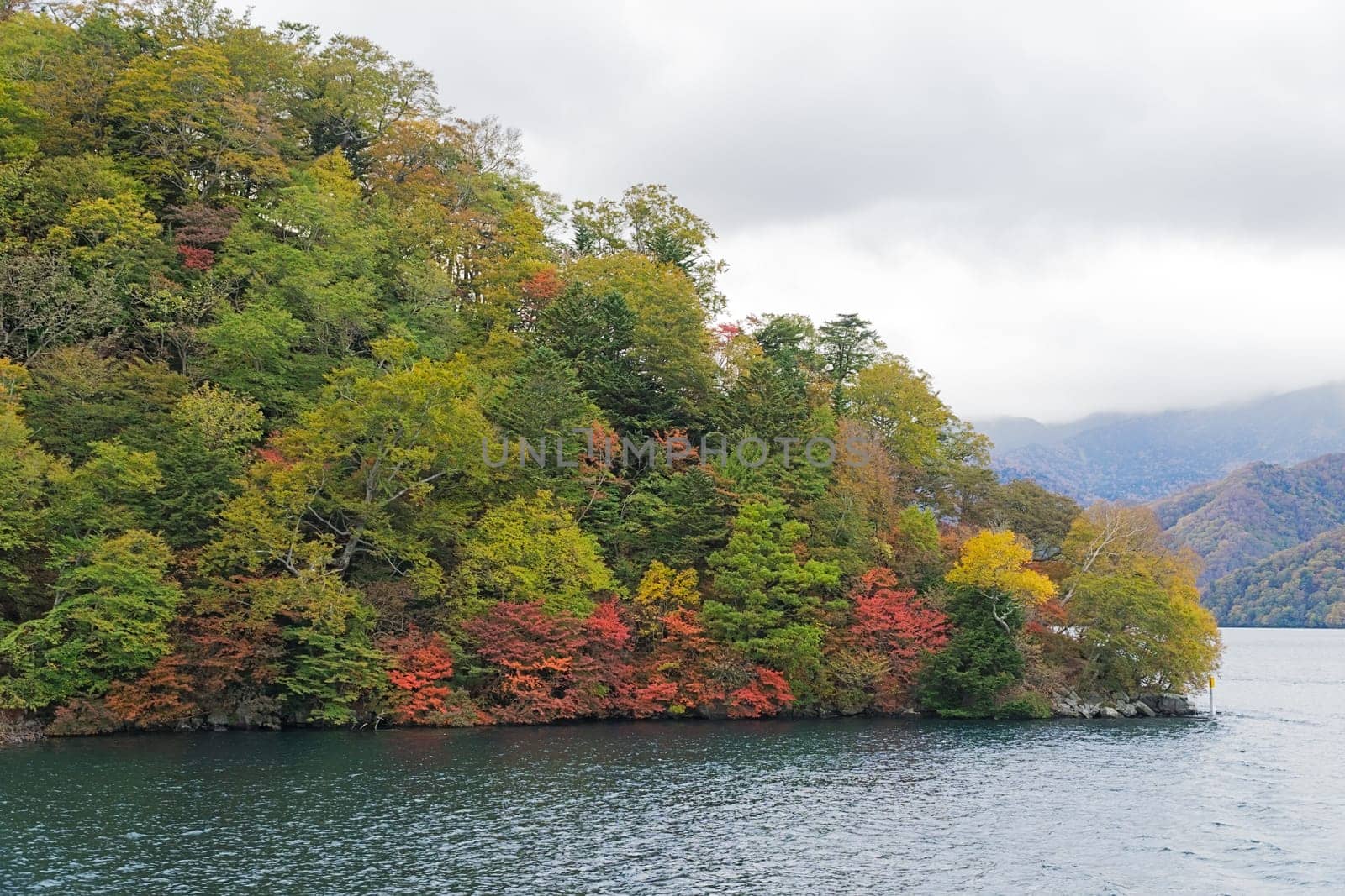 Lake Chuzenji is a scenic lake in the mountains above the town of Nikko. It is located at the foot of Mount Nantai, Nikko's sacred volcano, whose eruption blocked the valley below, thereby creating Lake Chuzenji about 20,000 years ago. This photo was shot in autumn