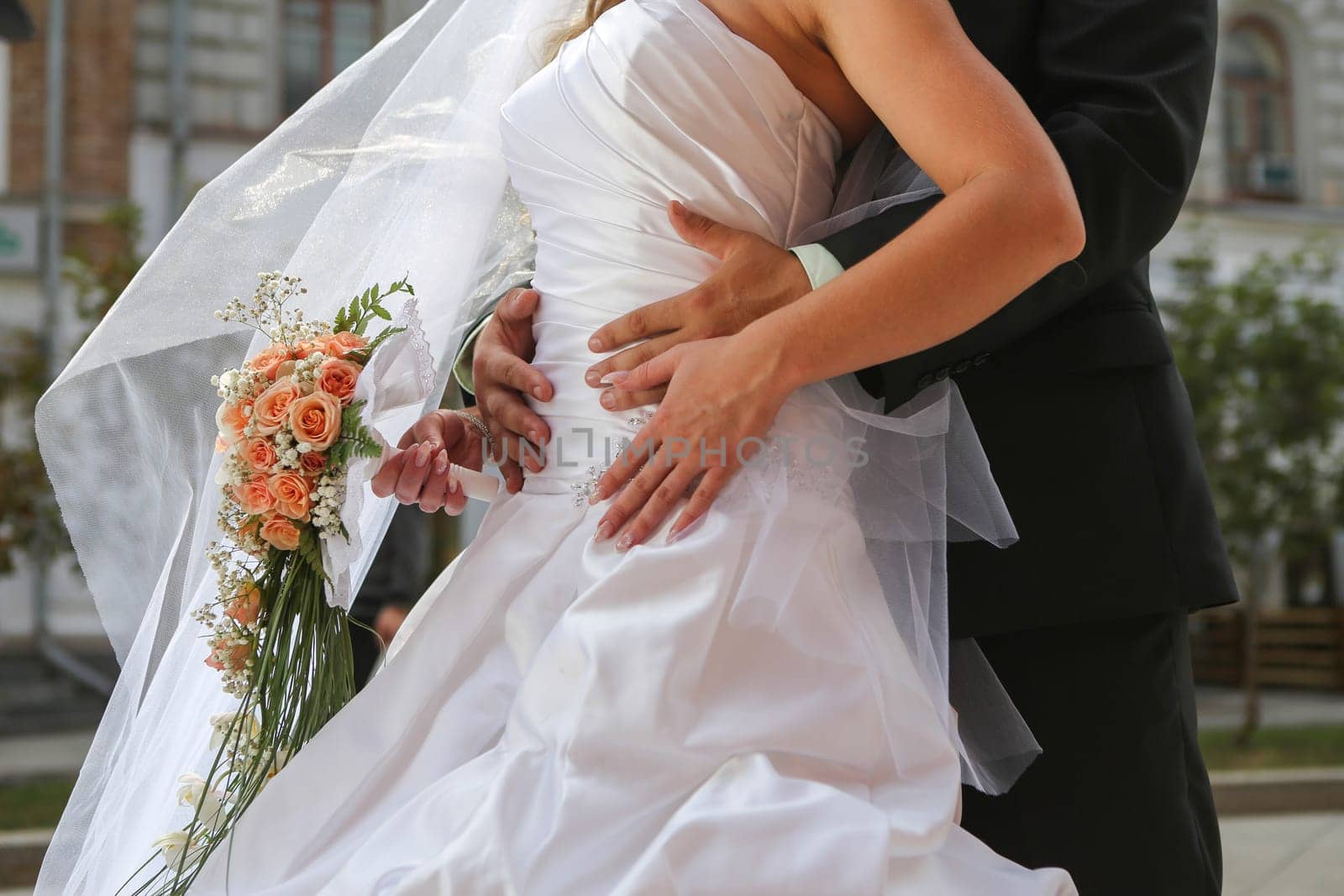 Bride with groom holding wedding bouquet at ceremony
